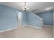 Open-concept living and dining area with modern flooring, fresh paint, and stylish chandelier at 2214 Bayswater Dr, Creedmoor, NC 27522