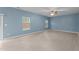 Bright living room boasts light-colored wood floors, blue walls, and two windows at 2214 Bayswater Dr, Creedmoor, NC 27522