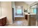 Bright bathroom with soaking tub, double vanity, and glass-enclosed shower at 222 Creststone Dr, Cary, NC 27519