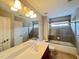 Bright bathroom with vanity, large mirror, modern lighting, and a shower-tub combination at 222 Creststone Dr, Cary, NC 27519