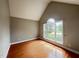 Bedroom featuring hardwood floors and a large window with natural light at 222 Creststone Dr, Cary, NC 27519