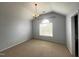 Bedroom featuring carpet, a chandelier, and a large window with natural light at 222 Creststone Dr, Cary, NC 27519