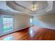 Spacious bedroom featuring hardwood floors, tray ceilings, and natural light at 222 Creststone Dr, Cary, NC 27519