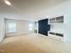 Spacious bonus room featuring built-in shelves, drawers, desk space and natural lighting at 222 Creststone Dr, Cary, NC 27519