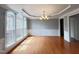 Dining room with hardwood floors, large windows, decorative trim, and chandelier at 222 Creststone Dr, Cary, NC 27519