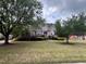 Charming two-story brick home with a well-manicured front lawn and mature trees at 222 Creststone Dr, Cary, NC 27519