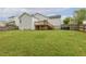 Spacious backyard features a wooden deck, lush lawn and a privacy fence, perfect for outdoor entertaining at 225 Lodestone Dr, Durham, NC 27703