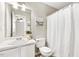 Bright bathroom featuring a white vanity, decorative mirror, and a shower with curtain at 225 Lodestone Dr, Durham, NC 27703
