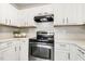 Bright kitchen showcasing stainless steel appliances and white cabinets with contemporary hardware at 225 Lodestone Dr, Durham, NC 27703