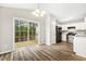 Eat-in kitchen with white cabinetry, stainless steel appliances, and sliding glass doors leading to the deck at 225 Lodestone Dr, Durham, NC 27703