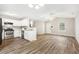 Open concept living room and kitchen featuring wood floors and stainless steel appliances at 225 Lodestone Dr, Durham, NC 27703