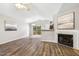 Spacious living room featuring wood floors, fireplace, and sliding doors to the outdoor patio at 225 Lodestone Dr, Durham, NC 27703