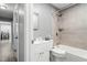Bright bathroom with shower and tub, white cabinets, and stone-look floors at 2314 Clements Dr, Durham, NC 27704