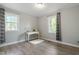Spacious bedroom with two windows and wood-look floors at 2314 Clements Dr, Durham, NC 27704