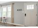 Bright foyer with a window and a white door, featuring vinyl flooring at 2314 Clements Dr, Durham, NC 27704