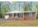 Charming brick ranch featuring a covered front porch and attached garage at 2314 Clements Dr, Durham, NC 27704