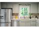 Updated kitchen featuring stainless steel appliances, countertops, gray cabinets, and a stylish backsplash at 2314 Clements Dr, Durham, NC 27704