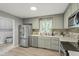 Charming kitchen features stainless steel appliances, stone tile backsplash, and natural light at 2314 Clements Dr, Durham, NC 27704
