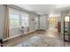 Cozy living room with large windows, hardwood floors, and a neutral color palette, creating a warm and inviting atmosphere at 2314 Clements Dr, Durham, NC 27704