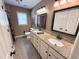 Bathroom featuring double sinks, granite countertops, and decorative mirrors at 2385 Olde Spring Ct, Graham, NC 27253