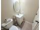 Powder room featuring a white vanity, modern fixtures, and neutral tiling at 2385 Olde Spring Ct, Graham, NC 27253