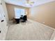 Bedroom with a neutral color scheme, features a ceiling fan, window, and a desk at 2385 Olde Spring Ct, Graham, NC 27253