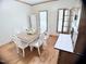 Bright dining room with a table, seating for six, and hardwood floors at 2385 Olde Spring Ct, Graham, NC 27253