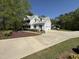 Two-story home with a spacious driveway, attached garage, and mature trees at 2385 Olde Spring Ct, Graham, NC 27253