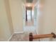 Upstairs hallway leading to the bedrooms with neutral carpeting and paint at 2385 Olde Spring Ct, Graham, NC 27253