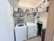Laundry room with modern washer and dryer and built-in storage shelving at 2385 Olde Spring Ct, Graham, NC 27253