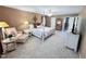 Spacious main bedroom with a four-poster bed, ceiling fan, and lots of room at 2385 Olde Spring Ct, Graham, NC 27253