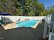 Backyard swimming pool surrounded by a white fence and lounge chairs for relaxation at 2385 Olde Spring Ct, Graham, NC 27253