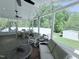 Covered porch with comfortable seating, offering views of the backyard and pool area at 2385 Olde Spring Ct, Graham, NC 27253