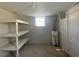Unfinished basement featuring shelving and water heater at 24 Pine St, Franklinton, NC 27525