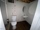 Functional bathroom with a toilet, sink, and round mirror for essential needs at 24 Pine St, Franklinton, NC 27525