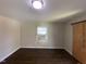Neutral bedroom features wood flooring, window, and wall air conditioner at 24 Pine St, Franklinton, NC 27525