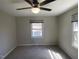Bright bedroom with windows and fan at 24 Pine St, Franklinton, NC 27525