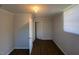 Bright bedroom with wood-look floors, a window and a doorway that leads to an open space at 24 Pine St, Franklinton, NC 27525