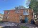 The back of the house with a door and windows, showing the brick exterior and some garbage cans at 24 Pine St, Franklinton, NC 27525