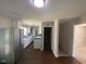 The kitchen features stainless steel refrigerator and wood flooring at 24 Pine St, Franklinton, NC 27525