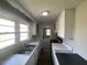 A well-lit kitchen with a double sink, white cabinetry, and a window overlooking the outside scenery at 24 Pine St, Franklinton, NC 27525