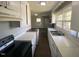 Bright kitchen features white cabinetry, a stainless steel sink, and modern appliances at 24 Pine St, Franklinton, NC 27525