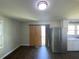 Living area with stainless steel refrigerator, wood flooring, and window at 24 Pine St, Franklinton, NC 27525
