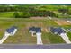 Aerial view showcasing the community featuring well-maintained homes, green lawns, and lush trees at 241 Indigo St, Lillington, NC 27546