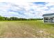 Green backyard with a view of the home and the screened-in porch, perfect for outdoor relaxation at 241 Indigo St, Lillington, NC 27546