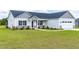 Single-Gathering home with gray siding, manicured lawn, stone accents, and a two-car garage at 241 Indigo St, Lillington, NC 27546