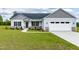 Charming single-Gathering home with a well-manicured lawn, two-car garage, and stone accents at 241 Indigo St, Lillington, NC 27546