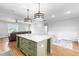 Open-concept kitchen with a large island, pendant lighting, and view of living and dining areas at 241 Indigo St, Lillington, NC 27546