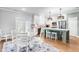 Open kitchen and dining area with island seating and access to the outdoors at 241 Indigo St, Lillington, NC 27546
