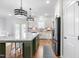 Bright kitchen boasts a large island, stainless steel appliances, and modern lighting at 241 Indigo St, Lillington, NC 27546